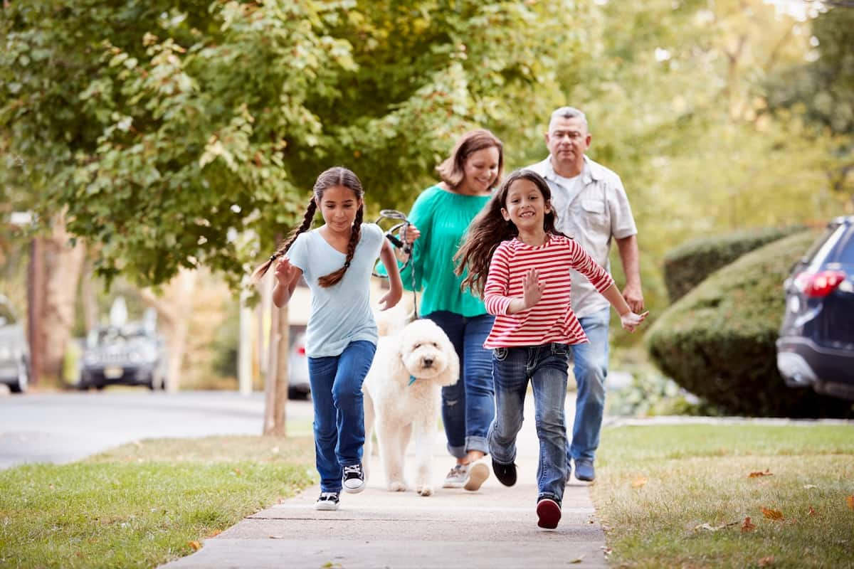 family walking in neighborhood